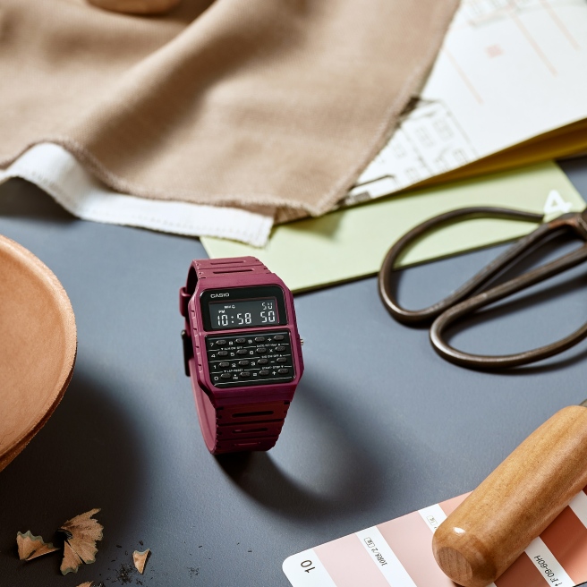 Zegarek męski marki Casio na czerwonym pasku z tworzywa sztucznego (poliwęglanu). Czarna tarcza z kalkulatorem i cyfrowym wyświetlaczem z wbudowanymi funkcjami: stoperem, alarmem, budzikiem, inteligentną datą i możliwością ustawienia dwóch czasów.